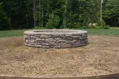 Mountain-drystack-stamped-over-concrete-block-retaining-wall-for-fire-pit