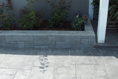 Stone-Edge-Surfaces-concrete-overlay-ashlar-slate-and-texture-stamp-on-patio-with-hand-carved-ashlar-and-texture-on-wall-5