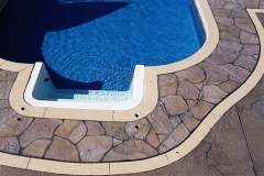 Stone-Edge-Surfaces-decorative-concrete-overlay-pool-deck-Swimming-pool-with-handcarved-slate-border-texture-stamp