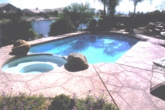 Stone-Edge-Surfaces-decorative-concrete-overlay-pool-deck-with-custom-boulders-61