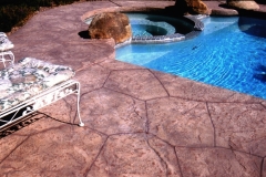 Stone-Edge-Surfaces-decorative-concrete-overlay-pool-deck-with-custom-boulders-64